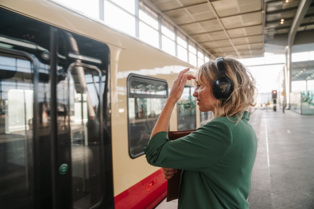 Frau trägt REAL BLUE PRO von Teufel, während sie in eine Berliner S-Bahn steigt