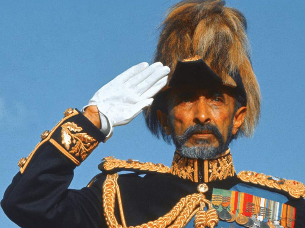 Haile Selassie in Paradeuniform mit erhobener Hand.